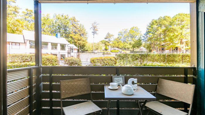 a balcony with a table and chairs and a view of the lake at The  Rowen