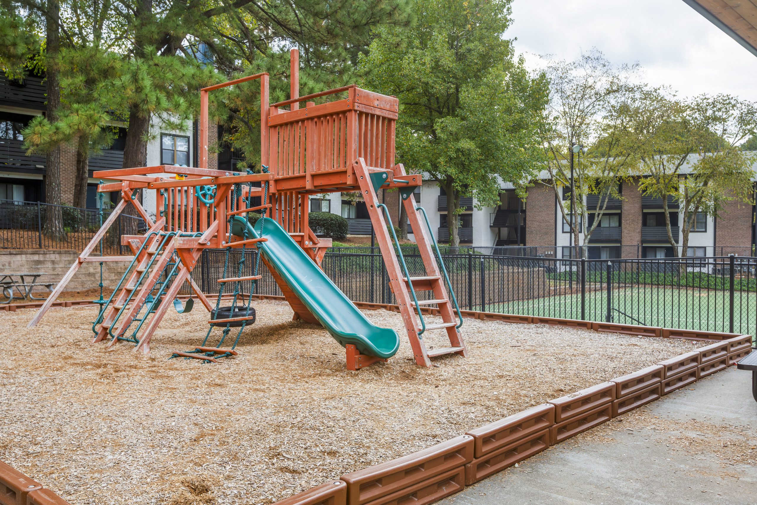 a playground set up in a courtyard with a slide at The  Rowen